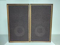 Front view of two HEATHKIT speakers with dark brown cloth grill covers in wooden frames.