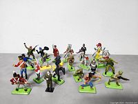 Front view showing all 12 toy soldiers in various colored uniforms and different stances on green bases.
