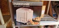 Box front showing Farberware Select Series pasta maker image with pasta shapes and branding.