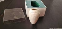 Lenox vase displayed outside the box showing white swirl design and clear plastic cover next to it