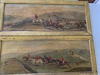 Two gilt-framed horse race prints stacked end to end