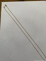 Full length of chain laid flat on white background