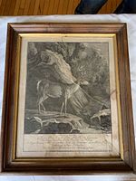 Full view of framed engraving showing the stag in rocky forest setting with visible broken glass and frame wear.