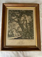 Framed copper plate engraving showing a deer hunting scene under a large tree.