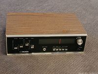 Front angled view of vintage Ross audio receiver showing wood grain casing and front panel controls including tuning dial and buttons.