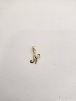 Photo showing the 10k gold pendant against a plain background