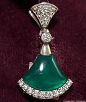 Clear image showing fan-shaped green onyx stone in pendant surrounded by cubic zirconia in sterling silver setting.