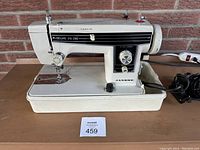 Side view of Janome Deluxe Zig Zag sewing machine showing model number 543118 on top and machine body with base and electrical cord.