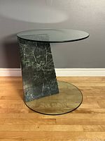 Front view showing round glass top, marble support, and round glass base