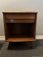 Front view of nightstand showing drawer and open shelf