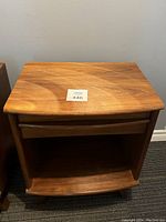 Front view of single nightstand showing drawer and open shelf
