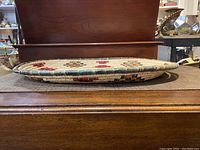 Side view of an oval basket tray showing thickness and weave detail