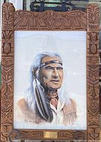 Full view of framed portrait print in carved wooden frame with metal easel brackets