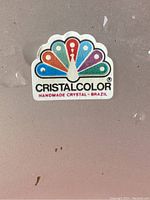 Close up of Cristalcolor brand label showing the handmade crystal from Brazil.