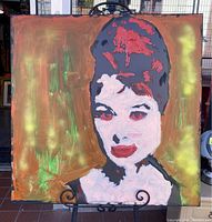 Full view of the painted portrait showing the stylized face against an orange and green abstract background.