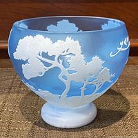 Front and side view of the blue frosted glass vase with white tree design and pedestal base