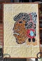 Full view of the framed mosaic tile artwork showing a profile of a person with detailed colored tiles.