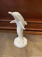Back angle of the porcelain dolphin highlighting overall shape and condition