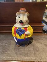 Full front view of the vintage piggy cookie jar showing the colorful outfit and overall shape