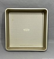 Top view of the square Oxo non-stick cake pan showing detailed textured bottom with Oxo logo.