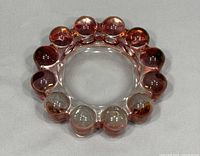 Top view of vintage pink glass ashtray showing round bubble edge and smooth center.