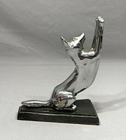 Side view of the silver-toned cat bookend with a raised front posture, mounted on a black rectangular base.