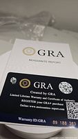 Photo of GRA Moissanite Report and warranty card providing certification and authenticity for moissanite.