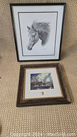 Two framed prints by A.J. Casson; one black and white horse head print titled 'Freedom Sound' and one colorful landscape titled 'Thunderheads'