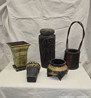 Full view of all five vintage containers arranged on a cloth background
