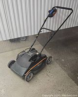 Full view of Black and Decker MM525 electric lawnmower showing handle, wheels, and body