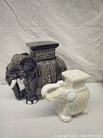Both ceramic elephant plant stands together showing size difference and design details