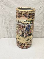 Full view of tall Satsuma vase showing central scenic women panel and surrounding elaborate floral design.