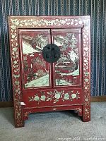 Full front view of cabinet showing painted landscapes and floral borders