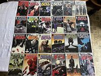 24 bagged and boarded Walking Dead comics arranged on table, issues #57–#78 plus two special editions visible