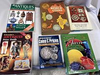 View of six catalogs and pricing guides arranged on a white cloth background, showing titles and cover art clearly for identification.