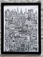 Framed black and white pen and ink drawing poster of Victoria city landmarks and sights shown in a black frame.