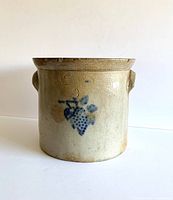 Front view of antique stoneware crock showing blue grape motif and impressed text including maker and Taunton, Mass