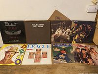 Photo showing the 6 vinyl records lined up: The Cult, Jesus Christ Superstar, Led Zeppelin, Cheap Trick, Devo, and Human League albums.