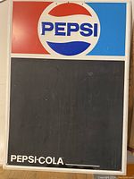 Front view of Pepsi chalkboard sign with Pepsi logo and chalkboard area.