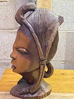 Front side view of the African wood carved bust showing detailed hair braiding and facial features.