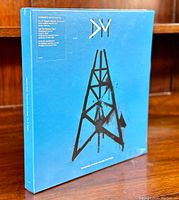 Blue boxset front cover with black tower design and text details on top.