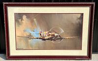 Full view of framed print showing Spitfire aircraft flying in a cloudy sky, providing an overall look at the artwork and frame.