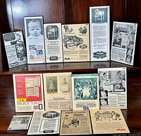 Photo shows 11 Maytag advertising plaques arranged on a wooden surface and against a wood-paneled background, showcasing vintage style ads from the 1930s to 1940s.