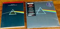 Photo showing the guitar tablature book on left and the sealed LP with original hype stickers on right with iconic album cover