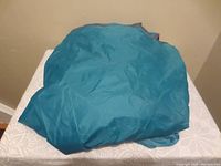 Teal nylon tent fabric folded and placed on table