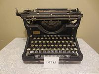 Front view showing keyboard with round glass keys and Underwood name on front bar