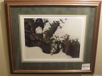 Photo of the framed print 'Winter Wren' by Robert Bateman showing the artwork, mats, and wooden frame with a label 'Lot 42'.