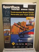 Box of SportRack Frontier Euro Trio Trunk-mounted Bicycle Carrier with product image and usage instructions visible on front.