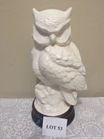 Photo of a vintage 12-inch tall ceramic owl sculpture in cream color with textured feathers, perched on a base.