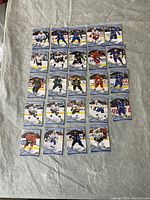 24 Upper Deck MVP hockey trading cards laid out, showing front side with players image and name.
